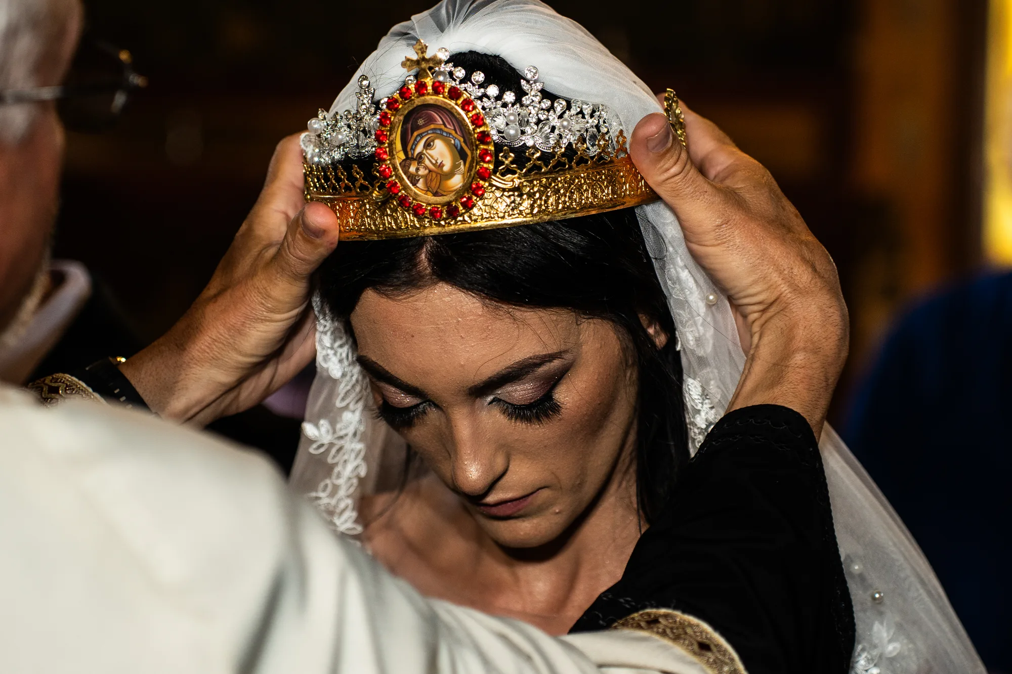 Coronița și voalul așezate pe capul miresei la gătitul miresei, tradiție de nuntă în Moldova, la o nuntă din Iași